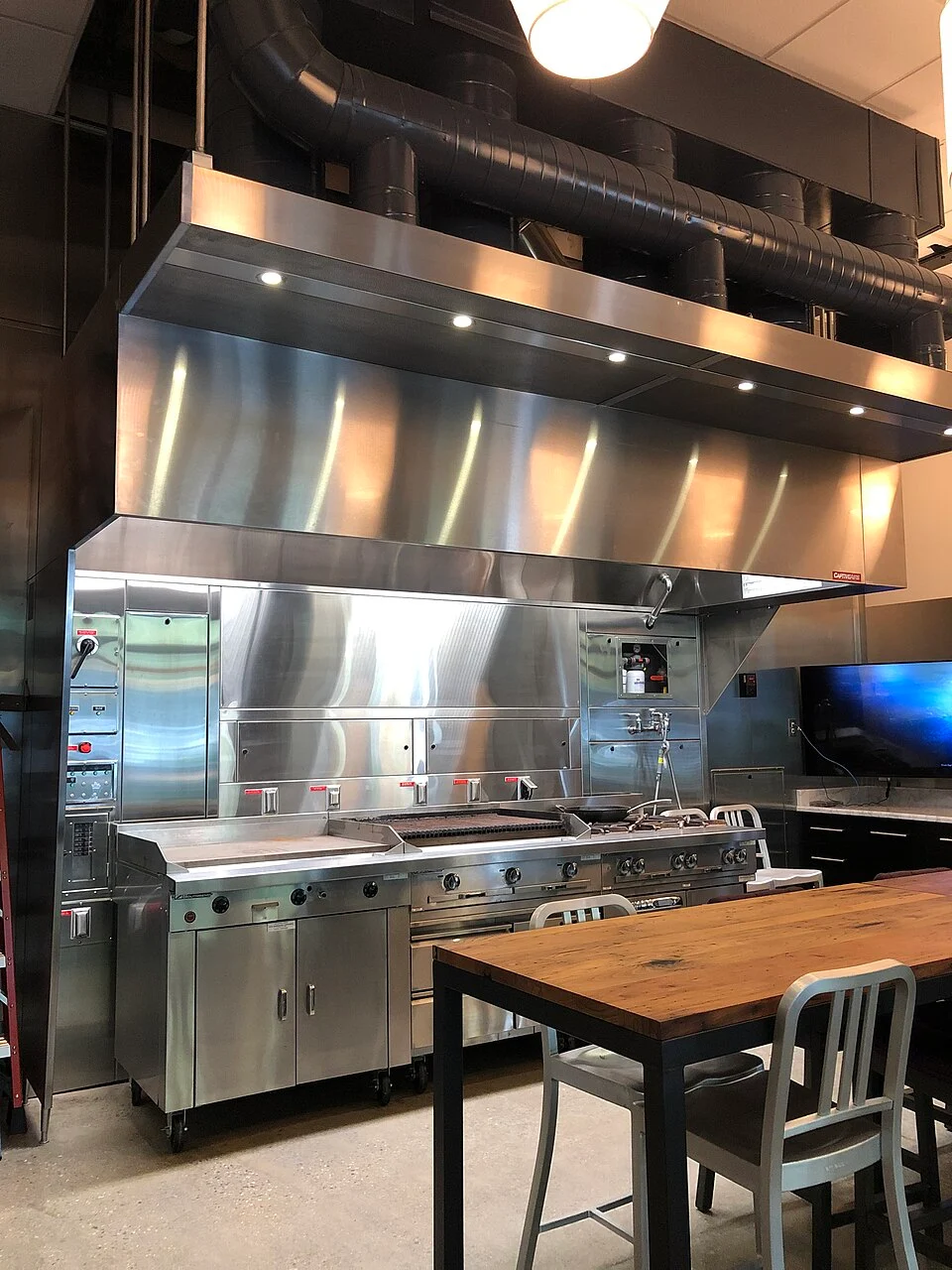 Representative stainless commercial kitchen exhaust hood; not a customer location